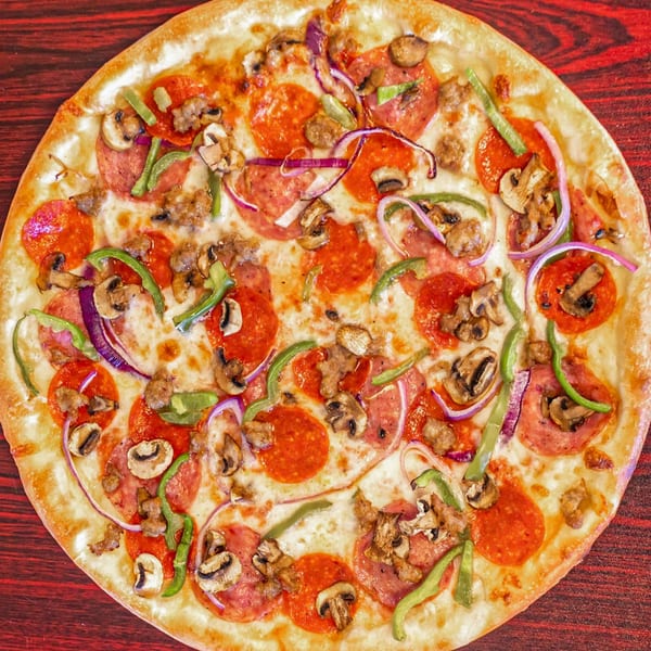 A Mr. Pizza Man pizza with pepperoni, sausage, mushrooms, green peppers, and red onions.